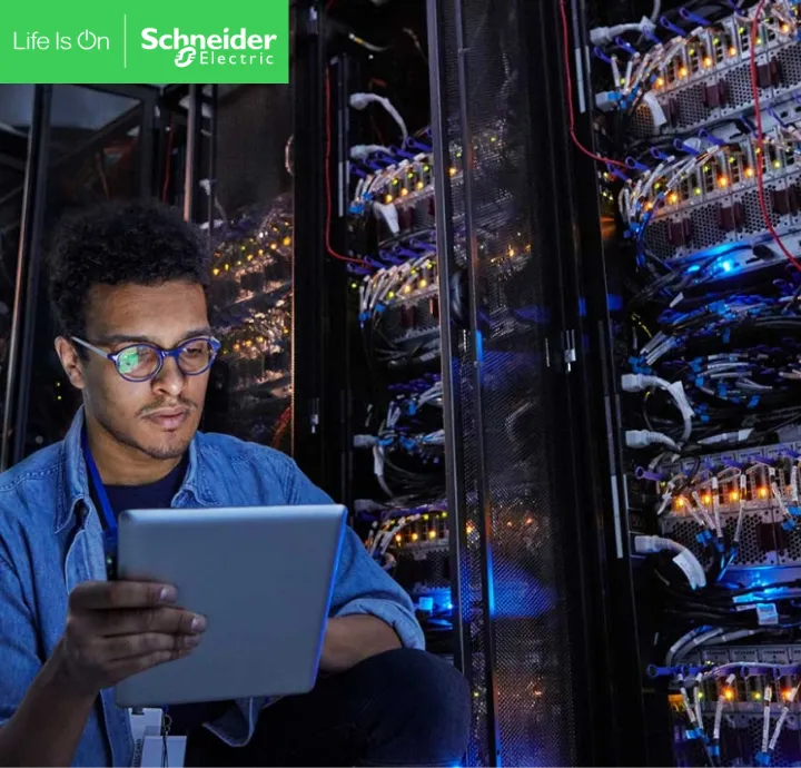 Engineer with a tablet in a Schneider Electric data centre